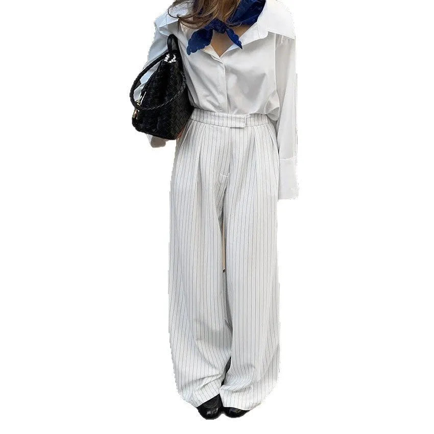 White striped wide-leg loose fit women's trousers with a zip fastening on a mannequin