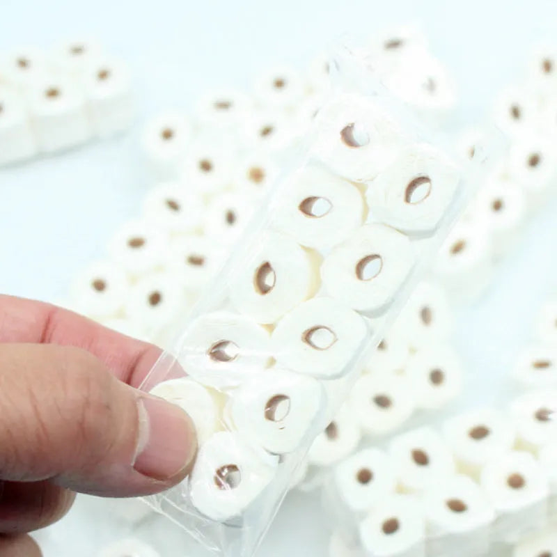 Miniature paper model of a toilet tissue roll for children's pretend play toys.
