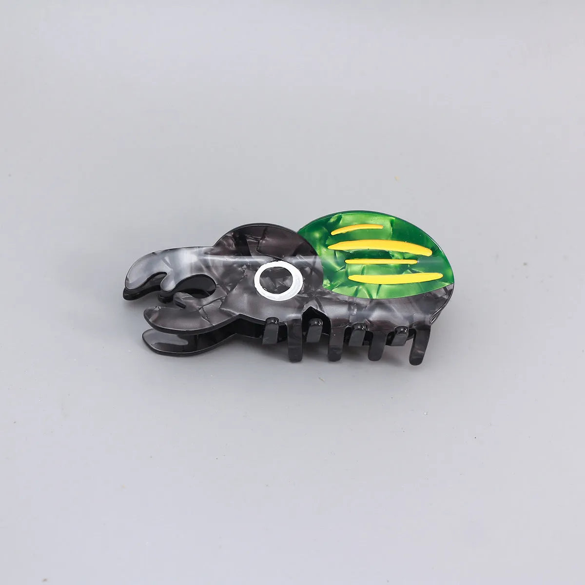 Handmade cellulose acetate beetle grip showing green beetle, orange beetle, and white caterpillar colour variants