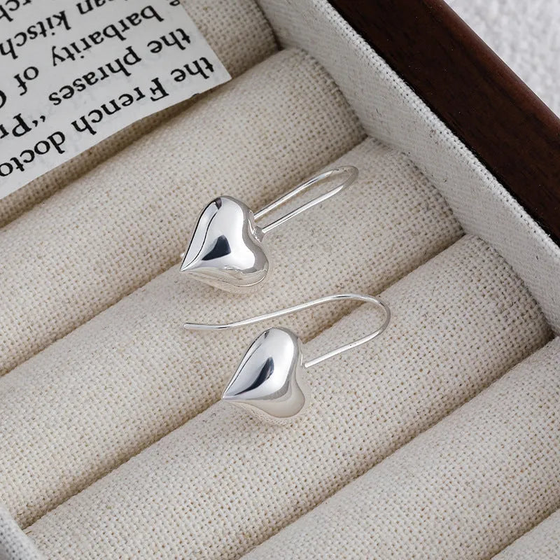 Korean style silver-coloured heart earrings with three-dimensional glossy finish and matching heart-shaped ear hooks
