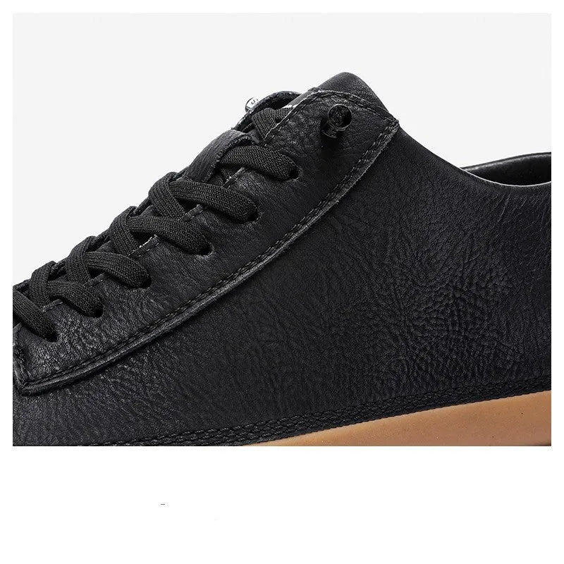 Men's black casual leather shoes with round toe, flat heel, and lace-up front on a white background.