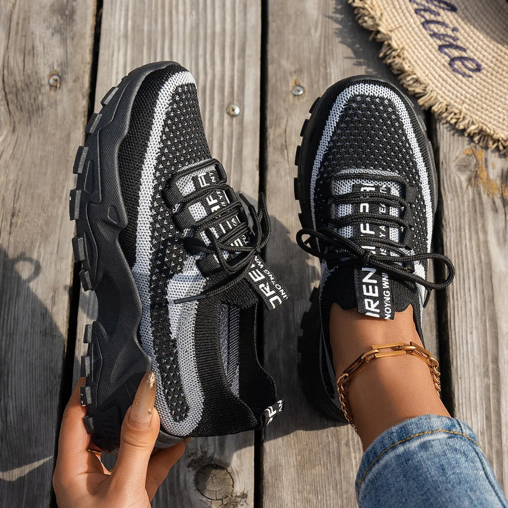 Women's Flyknit mesh lace-up sneakers in multiple colours with low flat rubber sole.