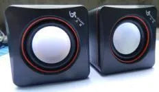 Small black square computer speaker with USB cable for desktop audio