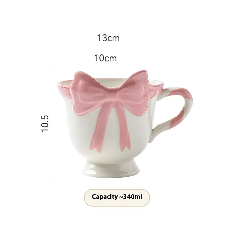 Ceramic mug with a decorative heart bow design in black pink or white powder colour.