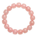 Pink natural crystal barrel bead bracelet with geometric shape on wrist