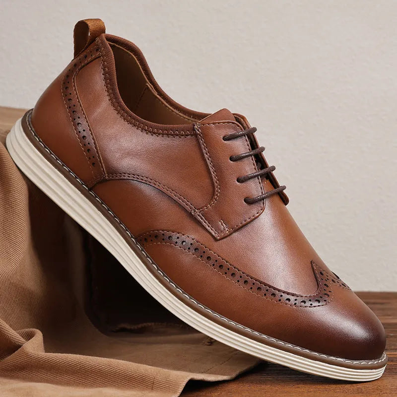 Men's black and brown slip-on casual shoes with round toe and carved detail on the upper.