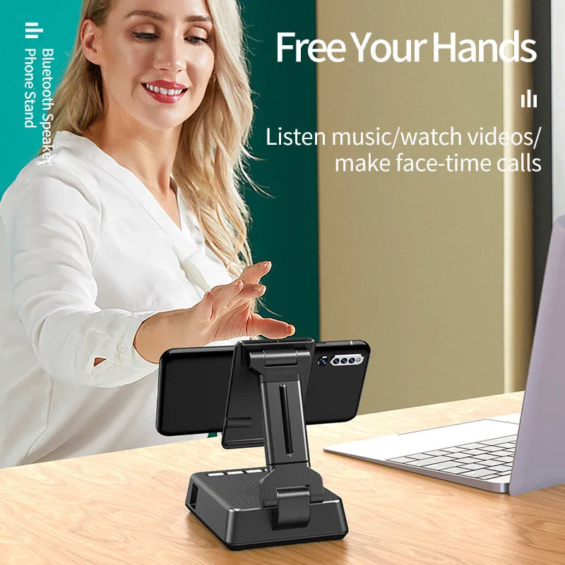 Black mobile phone broadcaster stand with wireless Bluetooth speaker and integrated HD microphone on desk