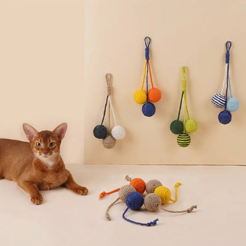 Four-piece cat toy set showing 255mm teaser wand with string, catnip ball, self-play wire, and fabric element in assorted colours