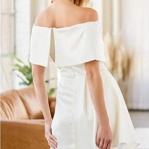 Women's white off-shoulder dress with lace-up back and high waist worn on a model.