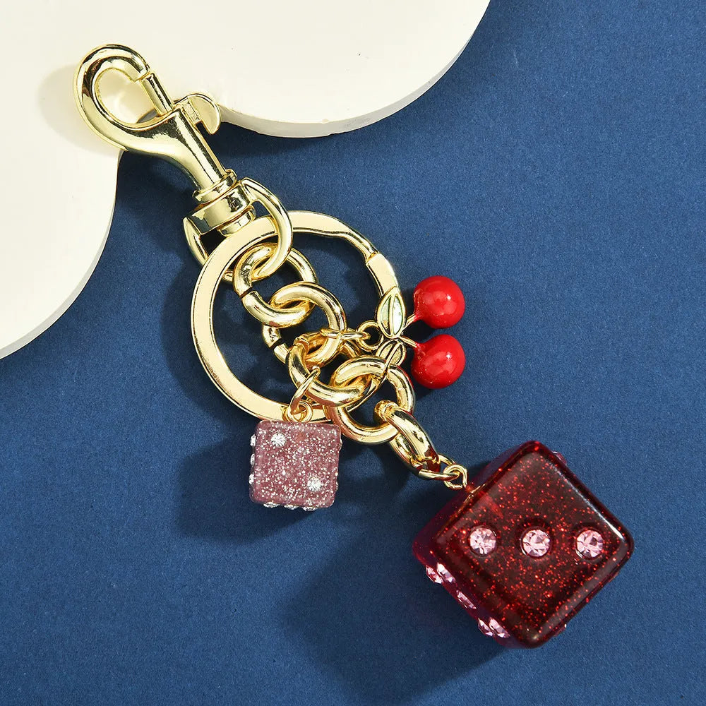 Square metal keychain pendant with a vintage cherry two-tone dice pattern for luggage or bags.