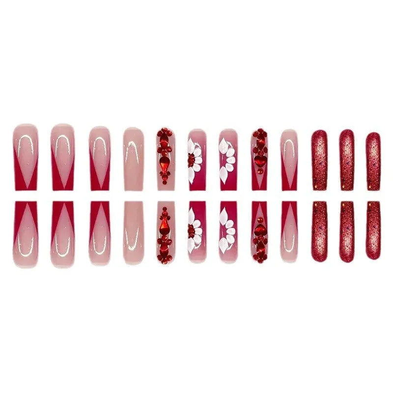 Artificial nails with red floral pattern and prismatic diamond decorations in long square shape