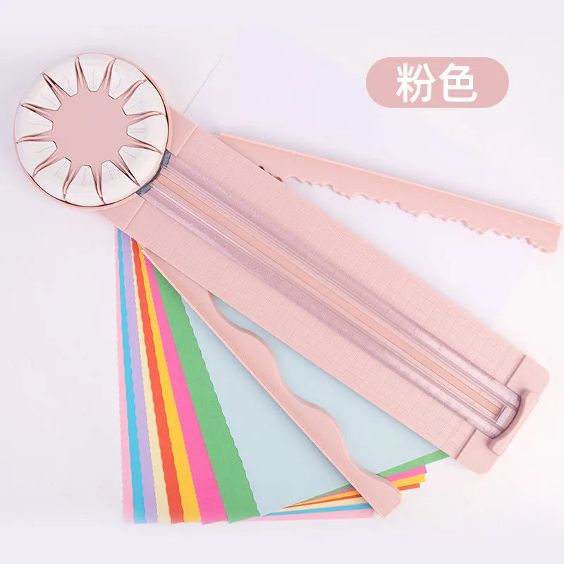 Pink plastic paper cutting machine with dotted pattern design and 12 interchangeable blades