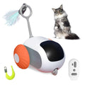 Blue and orange smart remote control cat toy car with feather teaser attachment on a home floor.