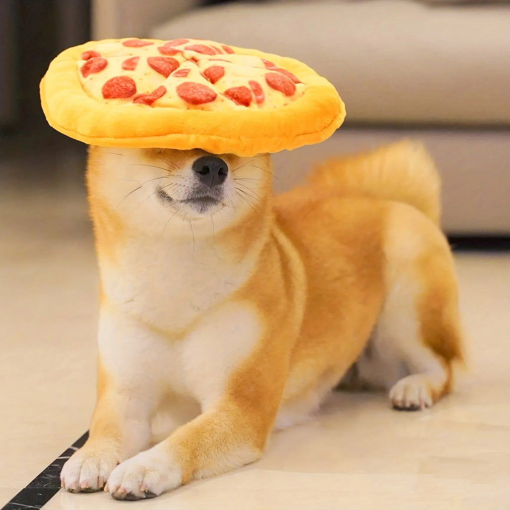 Yellow pizza slice shaped soft plush dog chew toy with squeaker on a white background.
