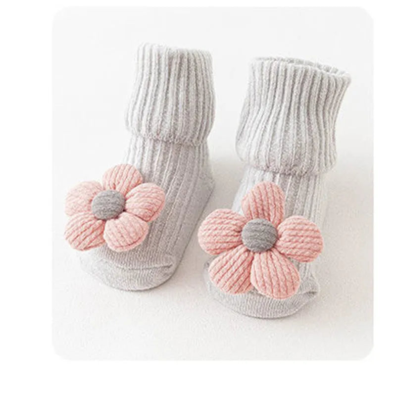 Cotton baby floor socks with non-slip soles in a pink bow print design.