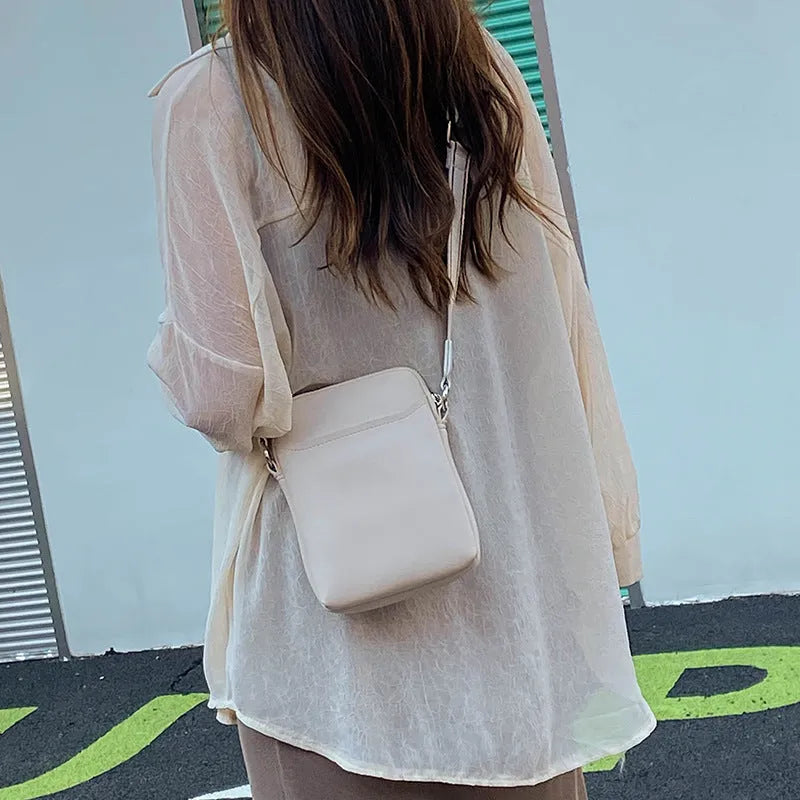 Small solid colour crossbody phone bag for women in beige.