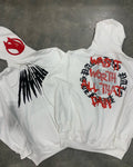 Black loose hooded sweatshirt with white printed skull design and rhinestone details on the front.