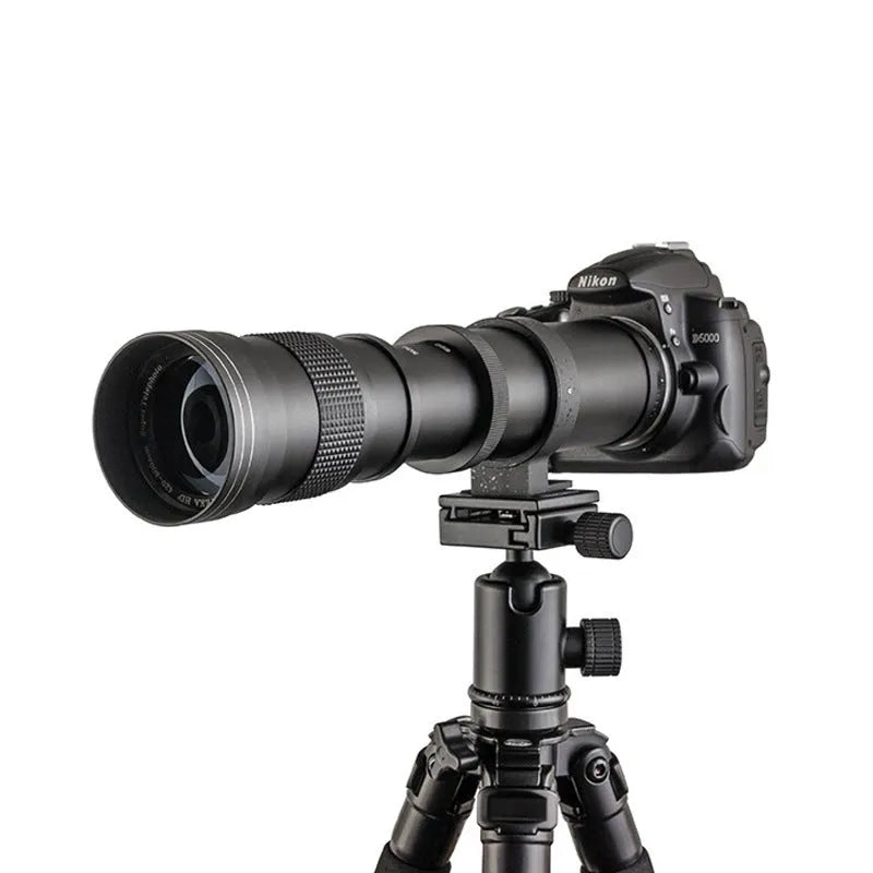 420-800mm manual telephoto zoom camera lens with T-port adapter ring on a table