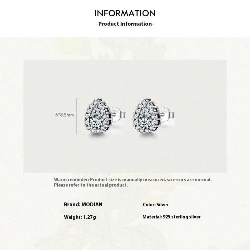 A pair of women's silver water drop shaped stud earrings on a plain background