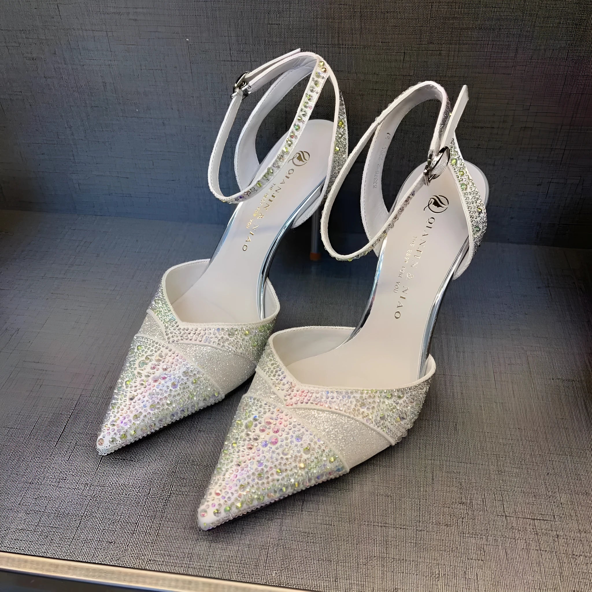 Women's black and silver hollow high heels with red sole and stiletto heel design