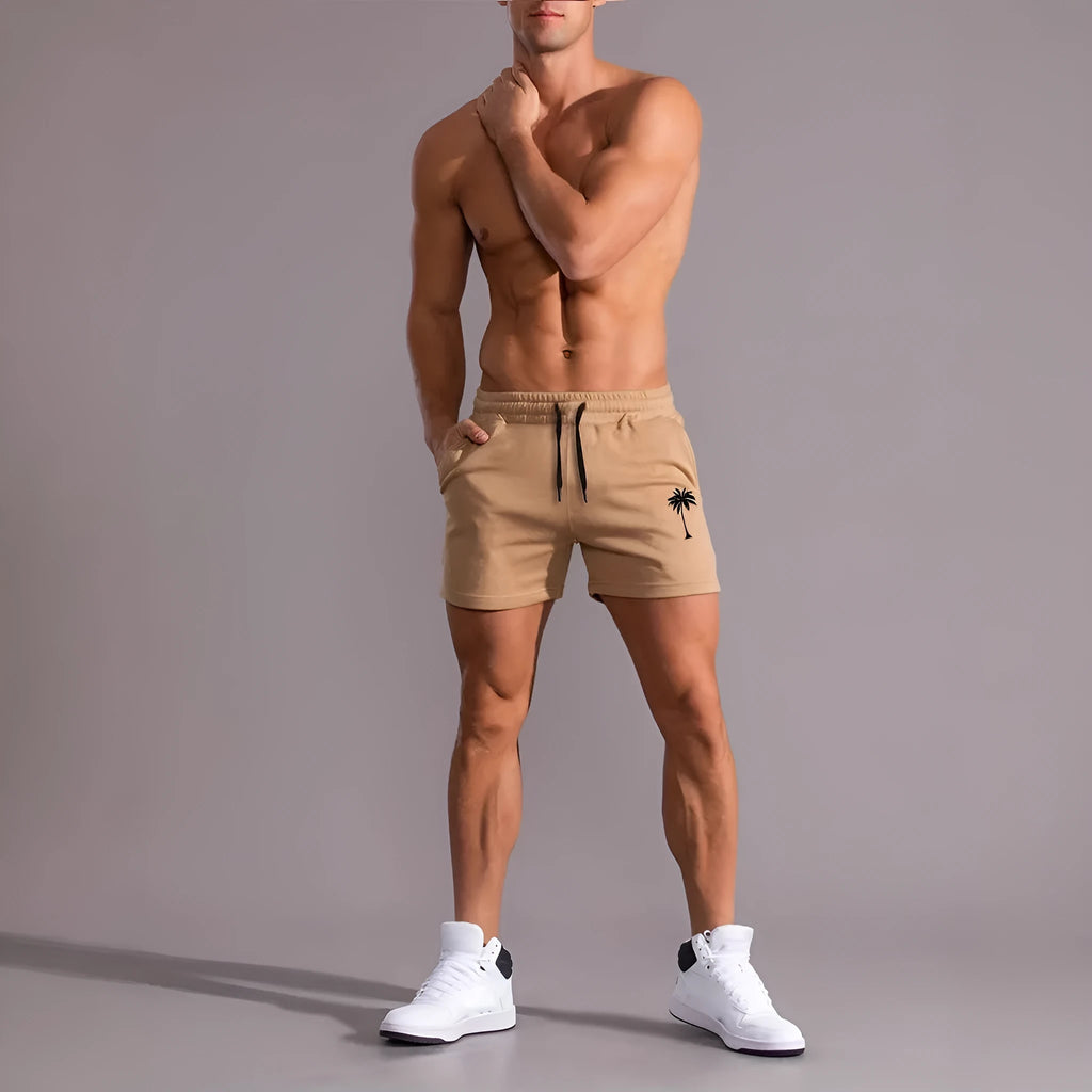 Khaki men's sports shorts with a white coconut leaf print, showing a straight leg and short length.