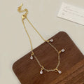 Women's zircon jewellery set showing geometric necklace, earrings, and anklet with meteor shower detail.