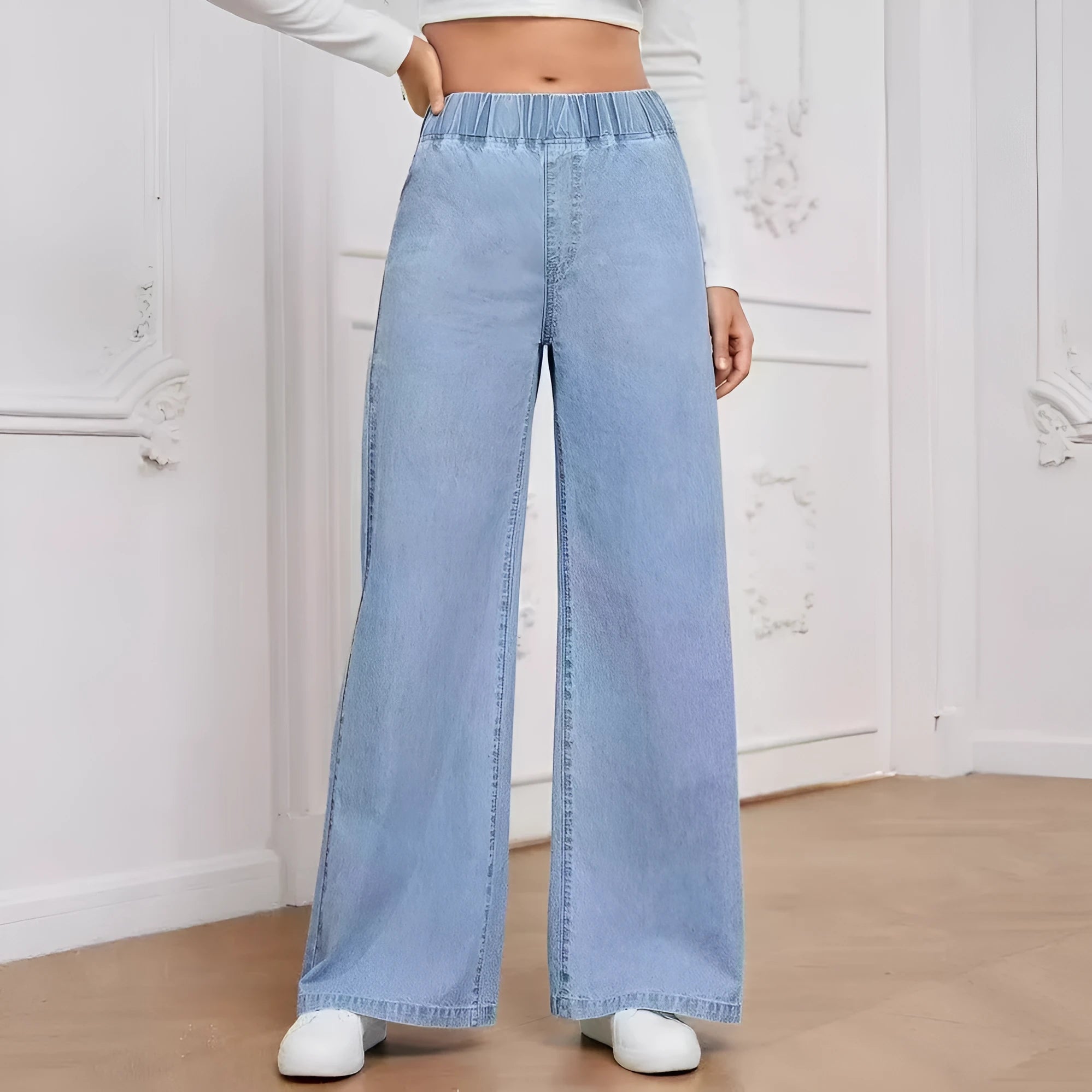 Light blue washed wide-leg denim trousers on hanger showing straight fit and mid-rise waist