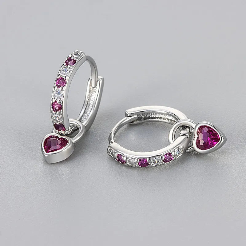 Women's gold tone earrings with a heart-shaped clip and a pink zircon drop pendant.