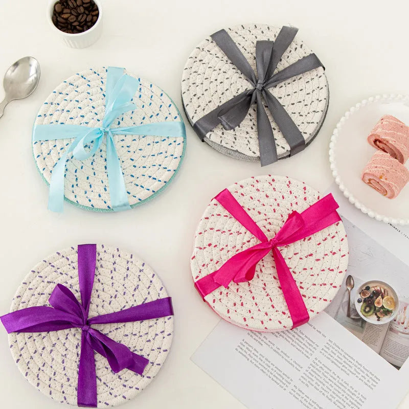 Set of three round cotton cord coasters in a choice of colours on a wooden table