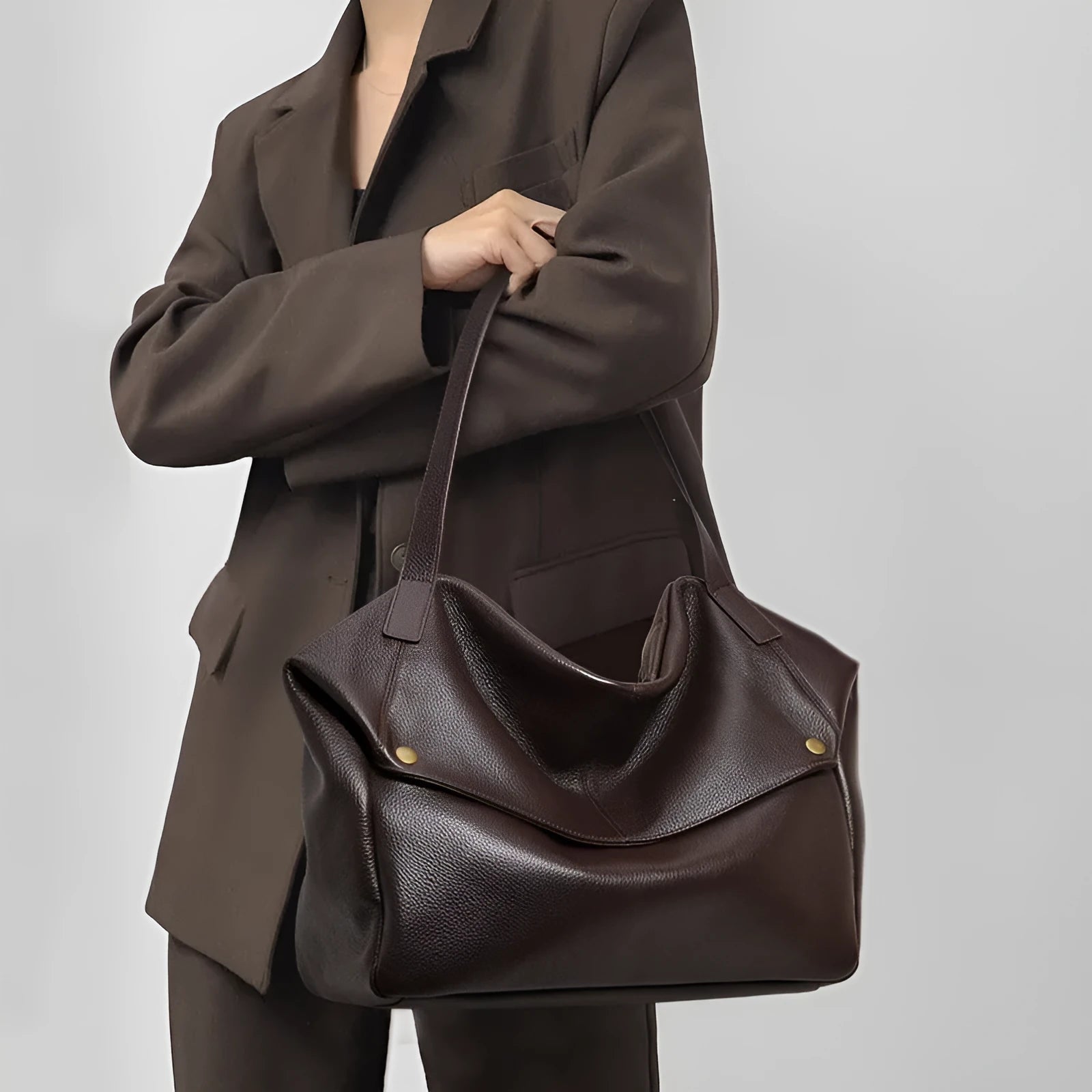 Brown genuine leather women's shoulder bag with a square shape and shoulder strap.