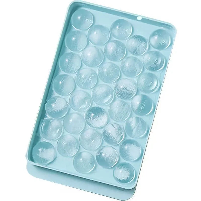 Round blue silicone ice cube tray with lid showing 33 compartments