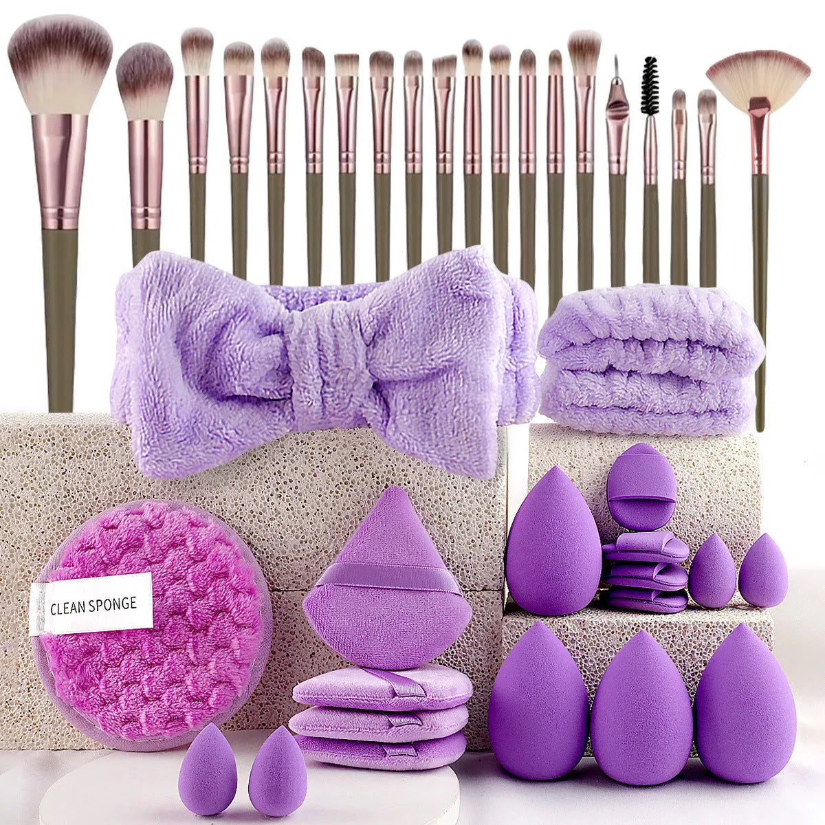 Beauty tool set with multiple pieces in brown, pink and purple colours for face wash and makeup application