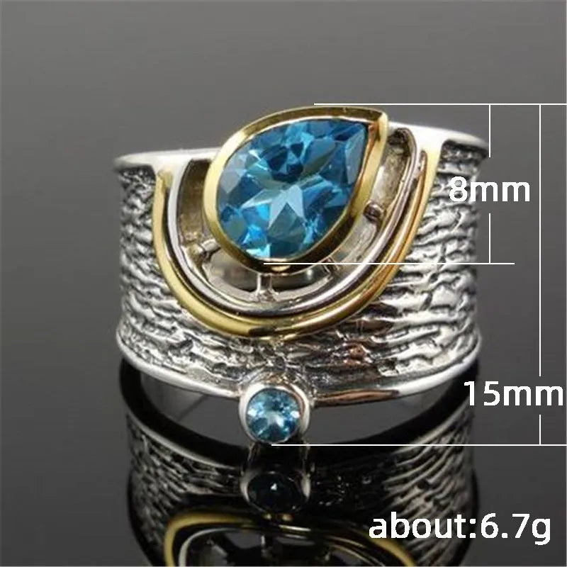 Chinese style blue zircon rhinestone alloy ring in a drop shape on a model's finger.