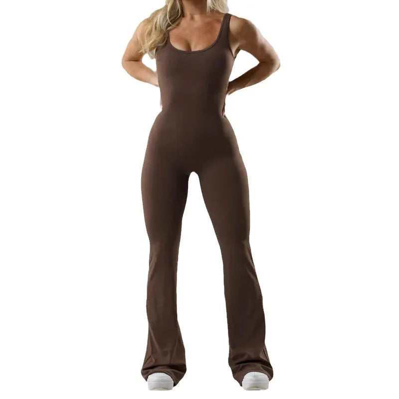 Woman wearing a black seamless yoga bodysuit with a hollow design detail and mid-waist fit.