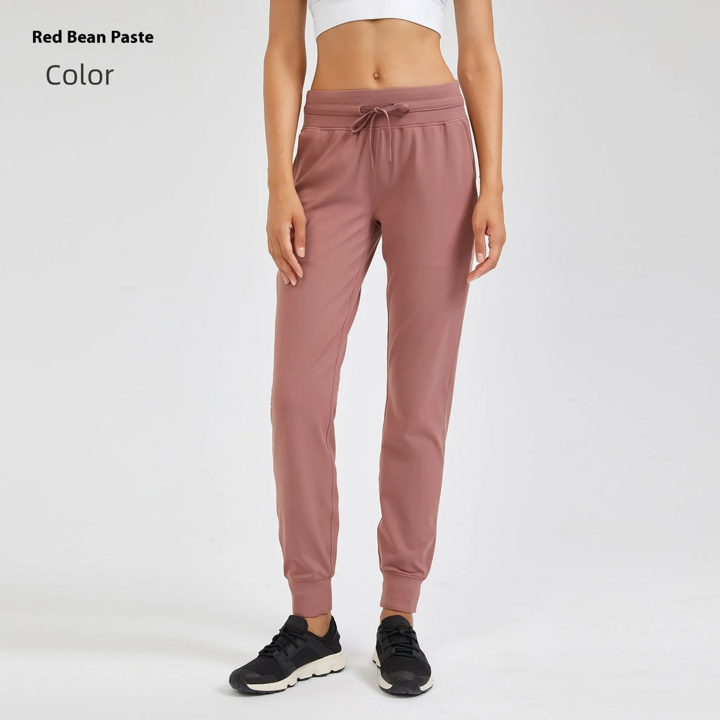 Women's high waist yoga pants with a drawstring waistband in a khaki colour.