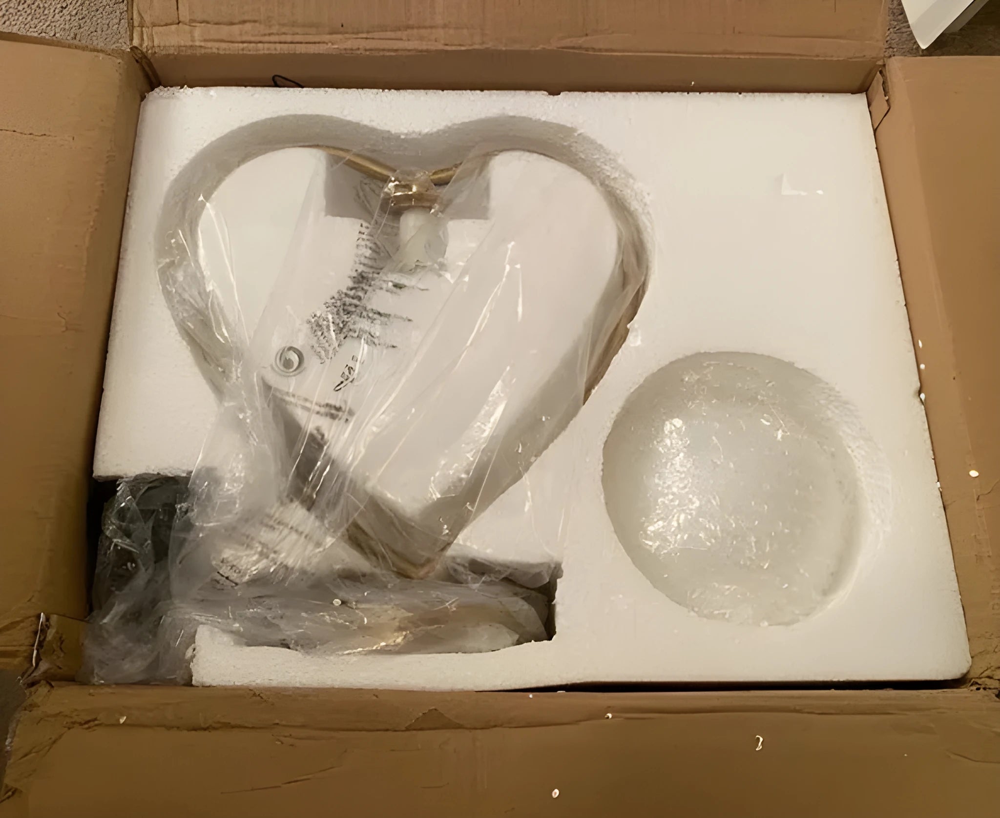 Rose gold heart-shaped decorative LED lamp on a surface