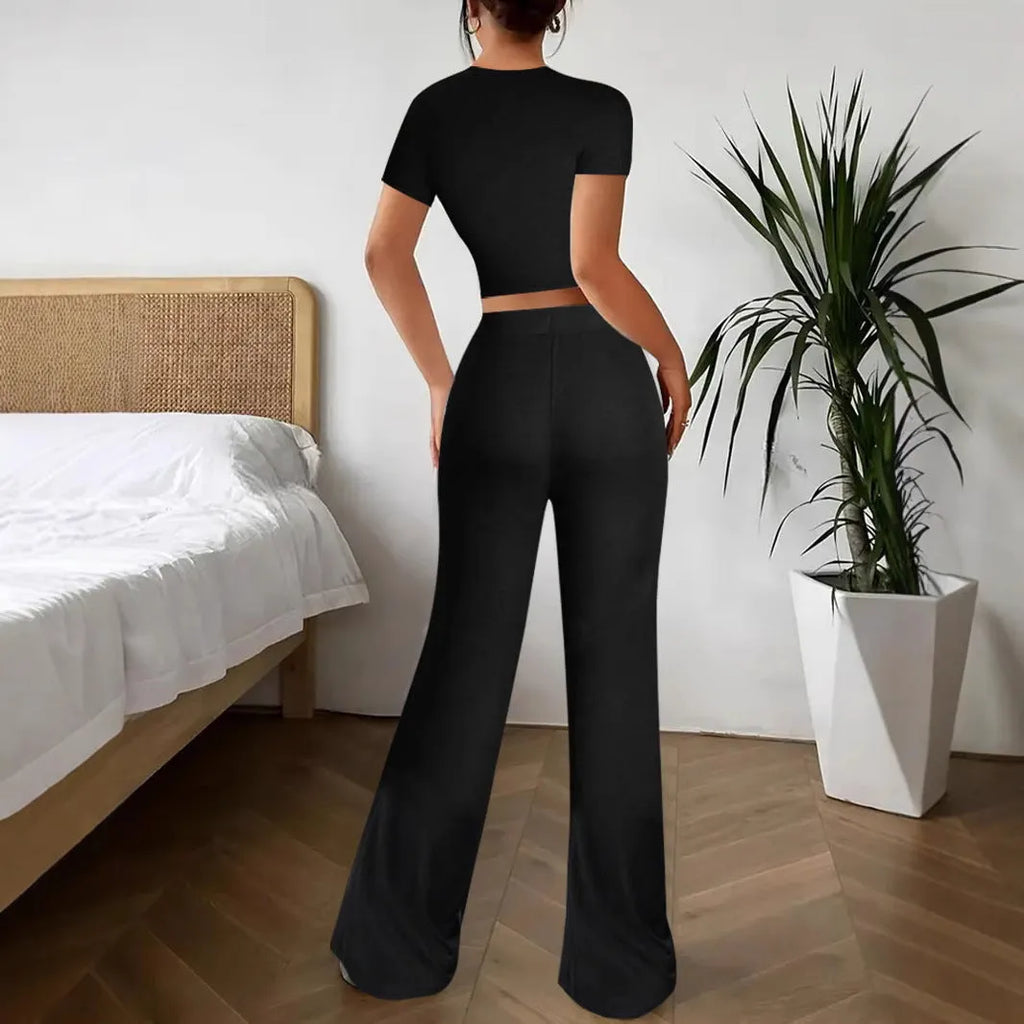 Women's black polyester trouser and T-shirt co-ord set showing complete outfit