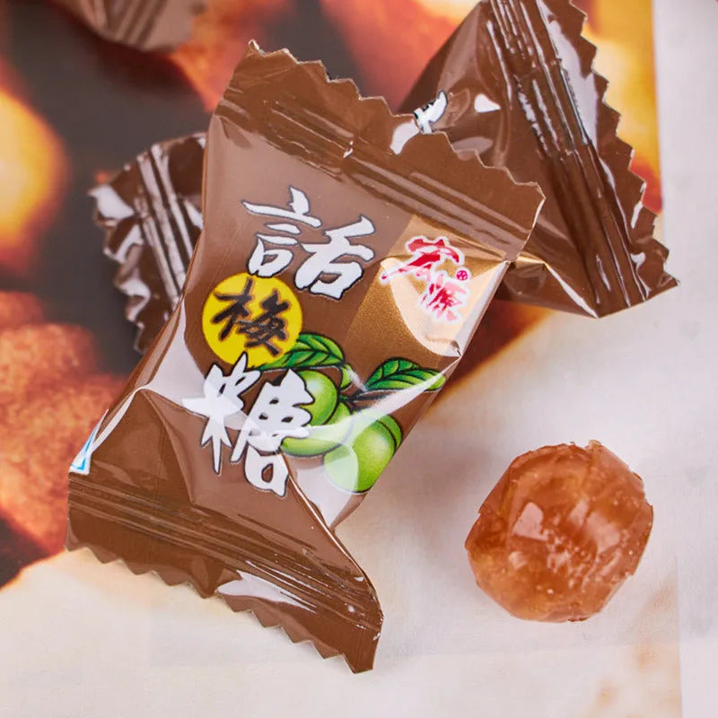 Three bags of Asian fruit hard candy: plum sugar, guava, and tangerine peel varieties with weight labels
