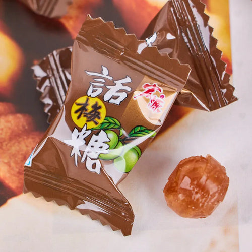 Three bags of Asian fruit hard candy: plum sugar, guava, and tangerine peel varieties with weight labels