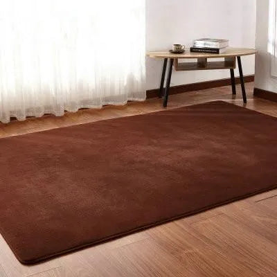 Solid colour fluffy plush carpet with non-slip dots on bottom, shown in beige on a wooden floor.