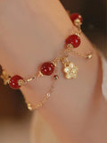 Women's double layer red agate bracelet with peach blossom flower elements and ethnic design