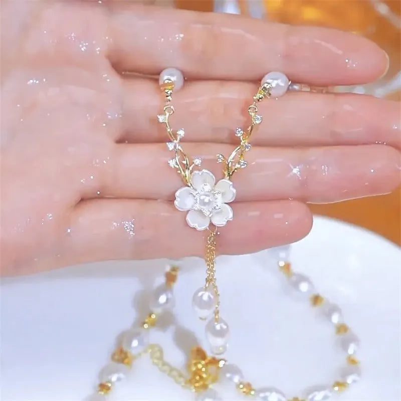 Pearl white alloy necklace with flower pearl charm and rose floral design elements on pearl chain