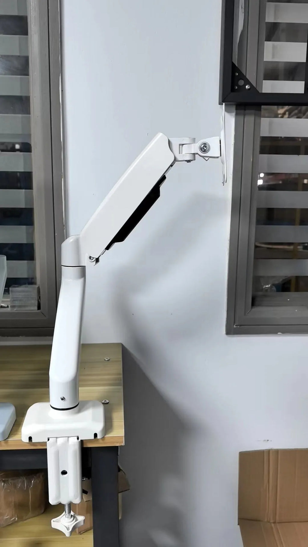 Black rotating telescopic LCD screen bracket with elevated storage rack on desk