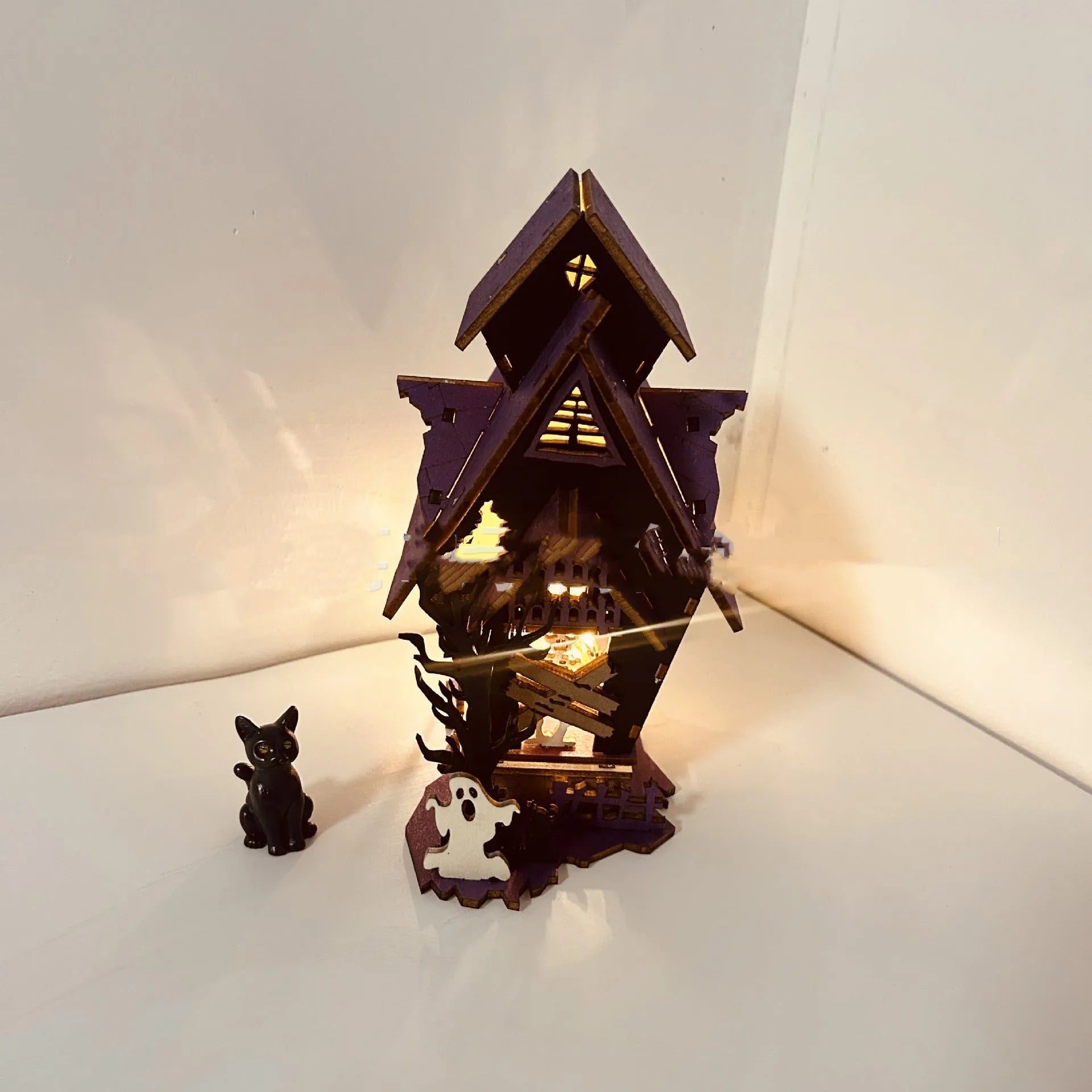 DIY wooden glowing haunted house Halloween decoration with candlestick holder, shown at 14x10.5x19cm size.