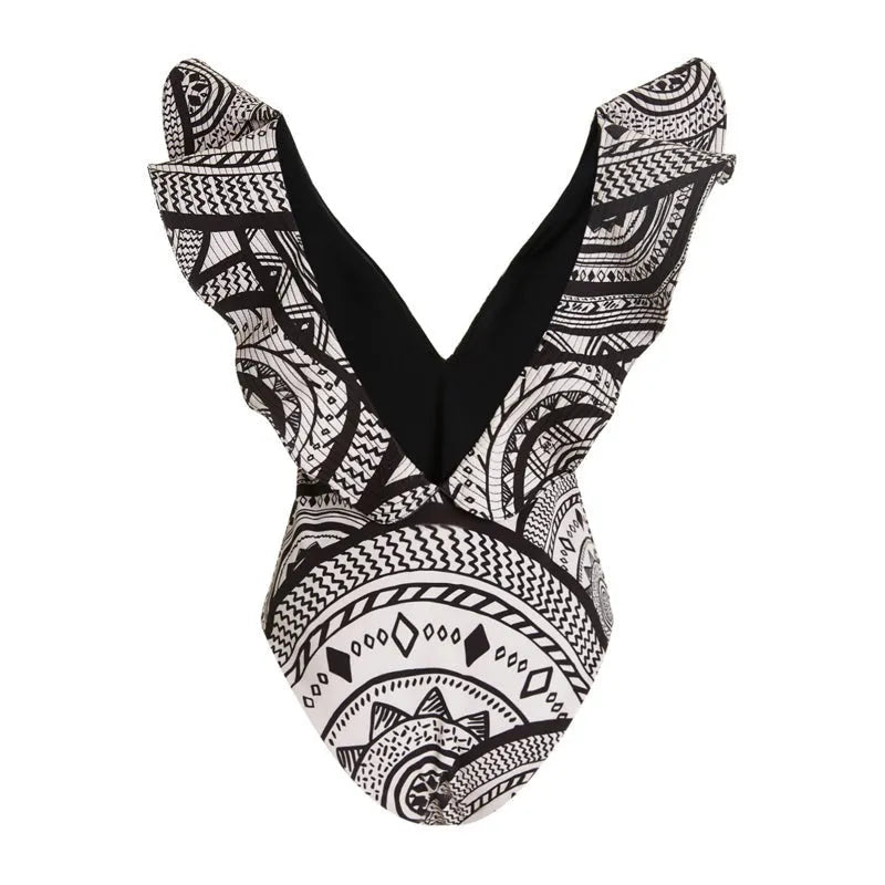 Women's deep V-neck vintage print one-piece swimsuit with matching wrap skirt on hanger.