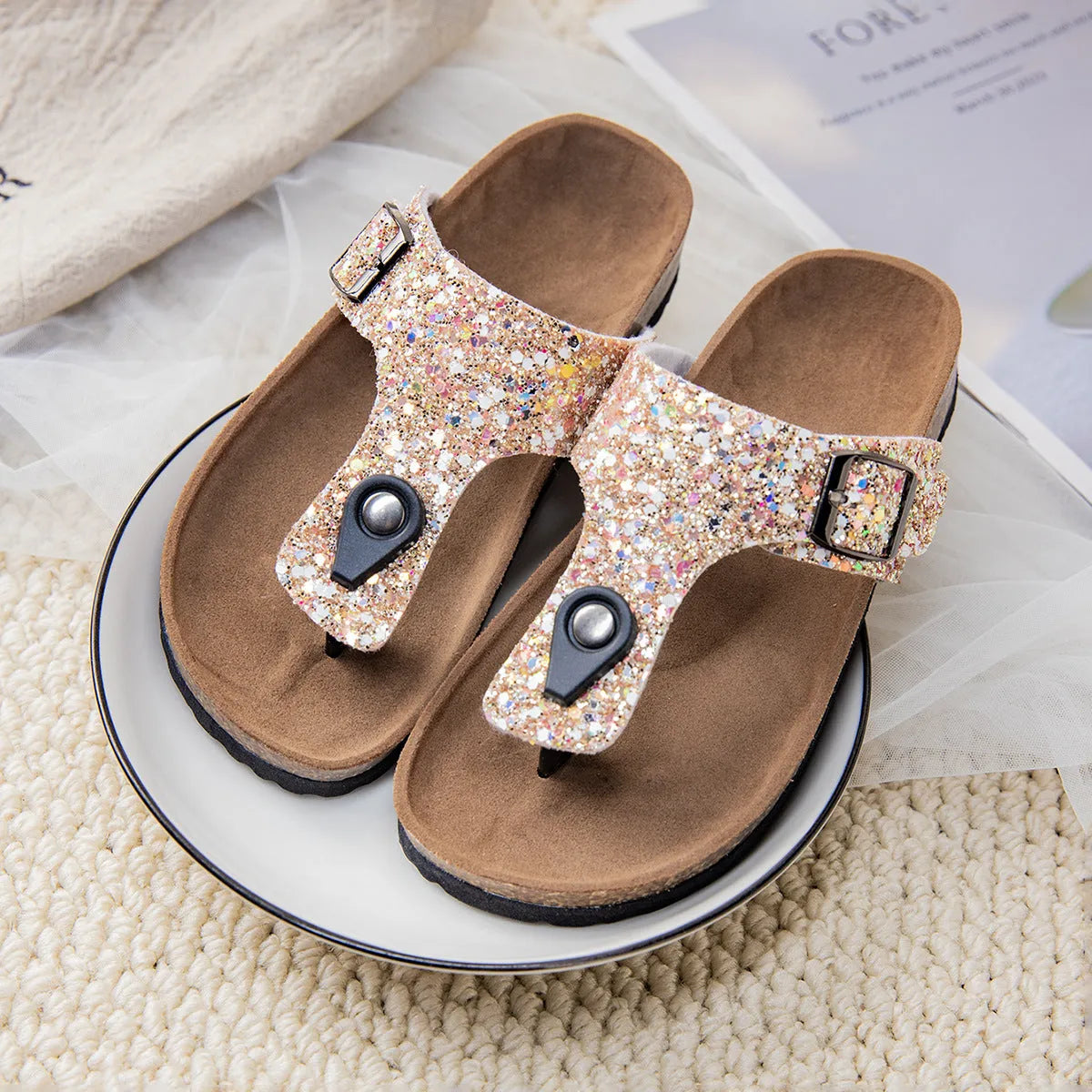 Gold cork flip-flops with a frosted artificial leather upper and a textured PVC sole.