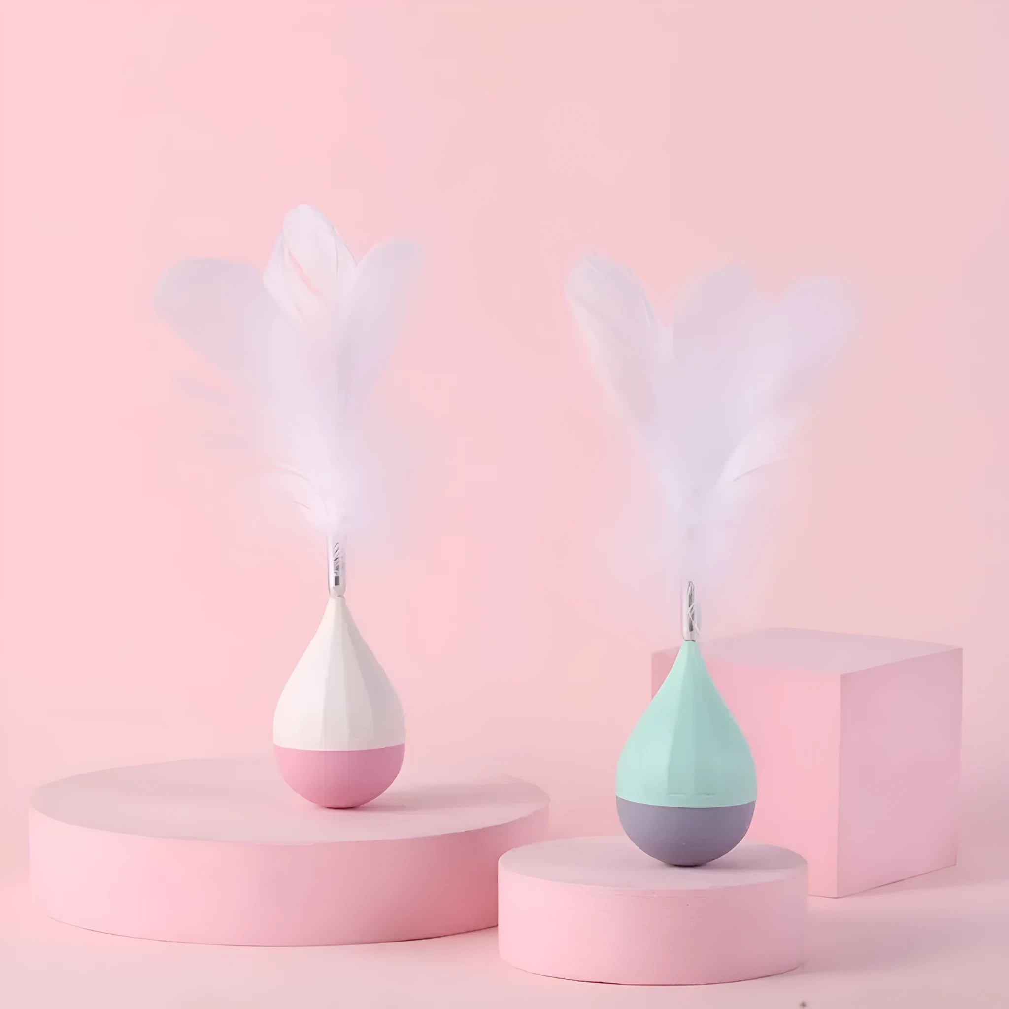 Green or pink feather tumbler cat toy with aluminium rod and self-healing ball component
