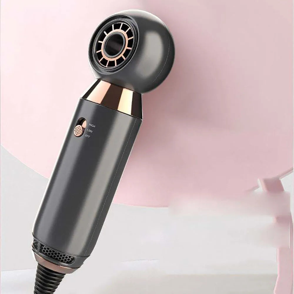 Compact white hair dryer with concentrator nozzle and diffuser attachment on a table.